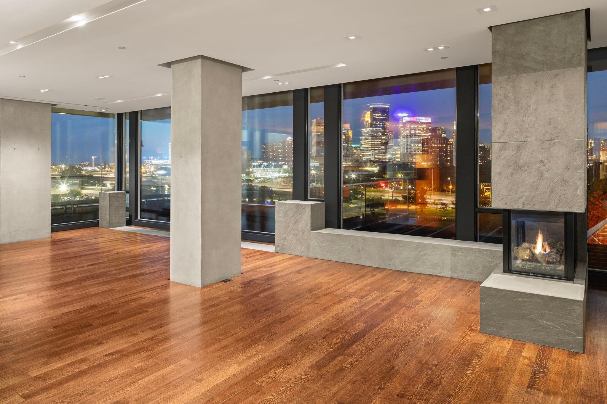 Section of Great Room with gas fireplace and walls of glass.