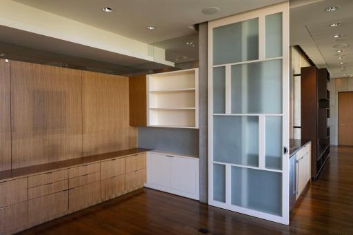 Office with extensive built-ins lies between family room & primary suite