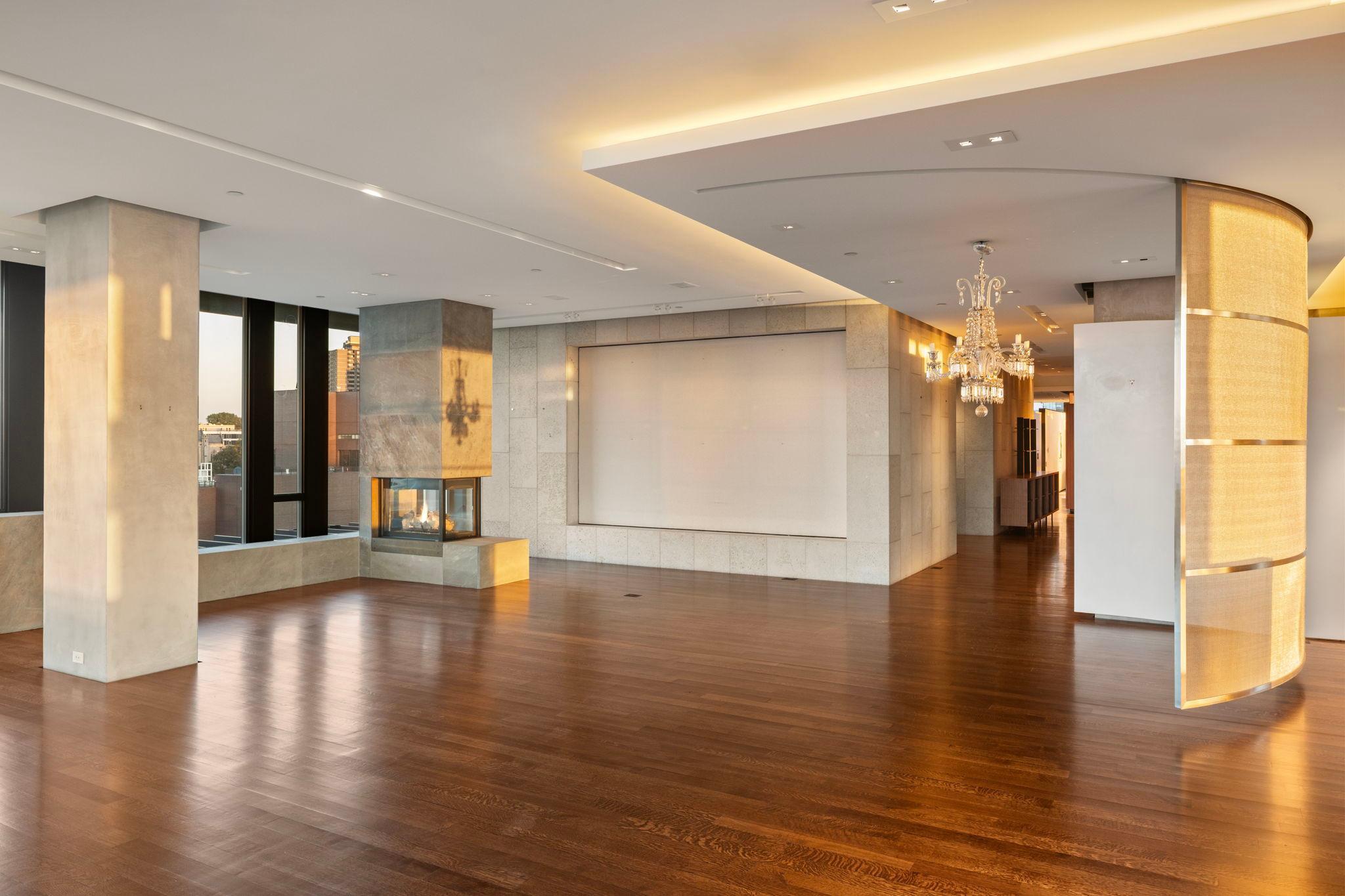 Another view of Great Room with fireplace and art wall.