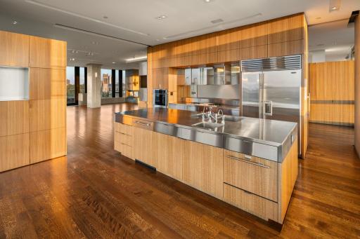 Custom designed center island kitchen with stainless steel counters and almost endless cabinetry