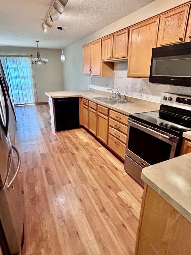 The kitchen. Ample amount of cabinets. Maytag electric range.