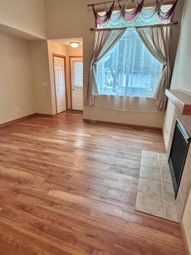 Step into the spacious family room with beautiful hard surface flooring and cozy fireplace. the family room