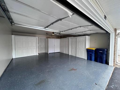 Garage with epoxy coated floor and walls with storage cabinetry