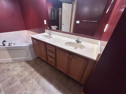 Double vanity and jetted tub of the primary bedroom