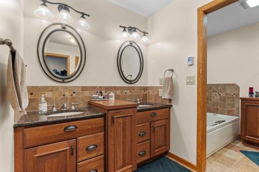 The private primary bath features double sinks, jetted tub and walk-in shower