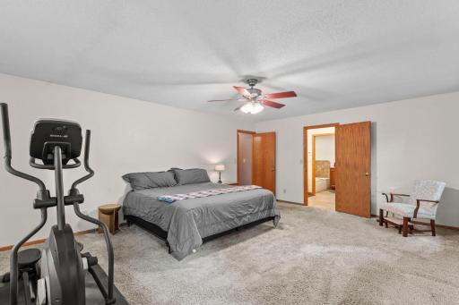 From the other side of the primary bedroom you can see the entry to the private bath and walk-in closet