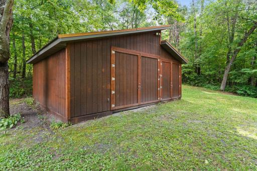 Attractive 24x21 pole building with a metal roof and cedar siding to match the house.