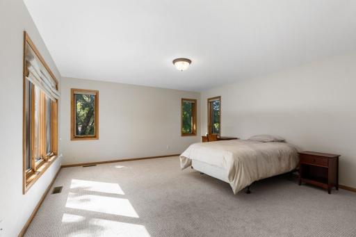Spacious third upper-level bedroom featuring brand-new carpet, abundant natural light, and the added convenience of its own private 3/4 bath.