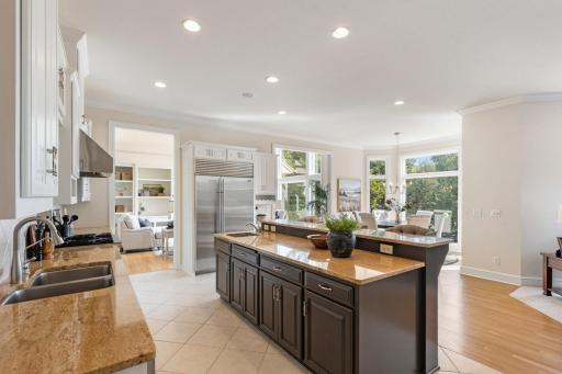 Spacious, light-filled kitchen featuring abundant cabinetry, a large center island, stainless steel appliances, and an open layout perfect for everyday living and entertaining.