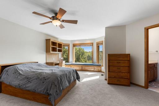 Spacious upper-level bedroom featuring brand-new carpet, a charming window seat with built-in storage.