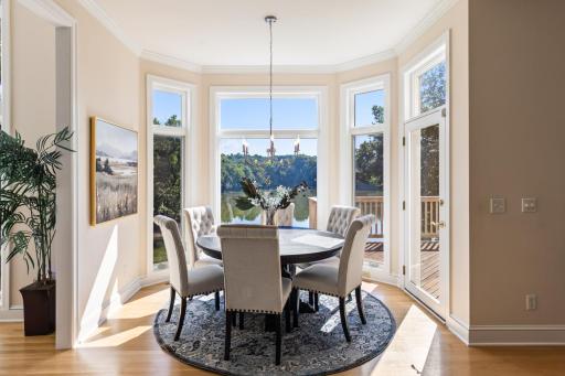 Sun-filled informal dining area surrounded by windows, offering beautiful views of Turtle Pond and convenient access to the deck.