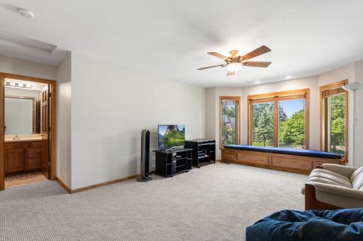 Generously sized second upper-level bedroom featuring brand-new carpet, abundant natural light, and a large window.