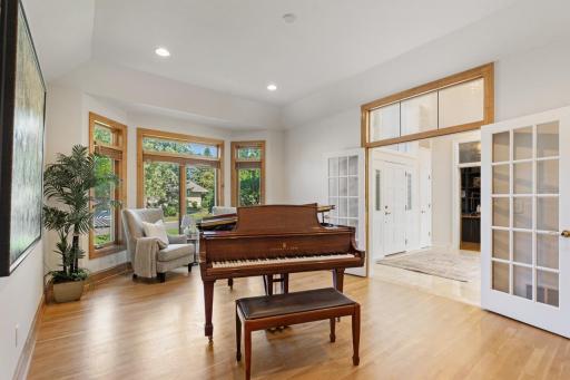 Versatile main-level space currently used as a music room, with beautiful hardwood floors, abundant natural light, and French doorsâalso perfectly suited as a formal dining room.