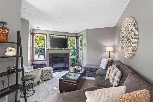 Spacious and bright family room with lots of windows and cozy fireplace!