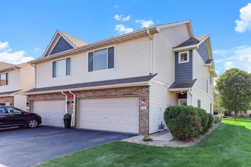 The exterior features a spacious two-car garage, attractive brick accents, and a covered entry that adds to the home’s welcoming curb appeal.