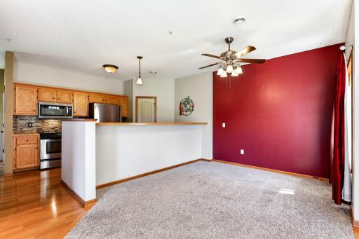 Open kitchen with breakfast bar overlooking a separate dining area, offering defined spaces while maintaining an open, connected feel.