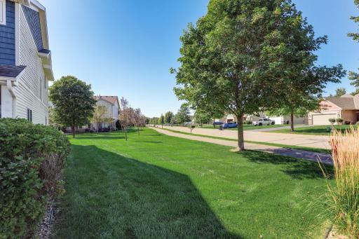Desirable end-unit setting offering one of the largest outdoor spaces, with expansive green space, mature trees, and a spacious side yard.
