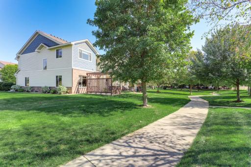 Desirable end-unit setting surrounded by expansive green space, mature trees, and community walking paths just steps from the home.