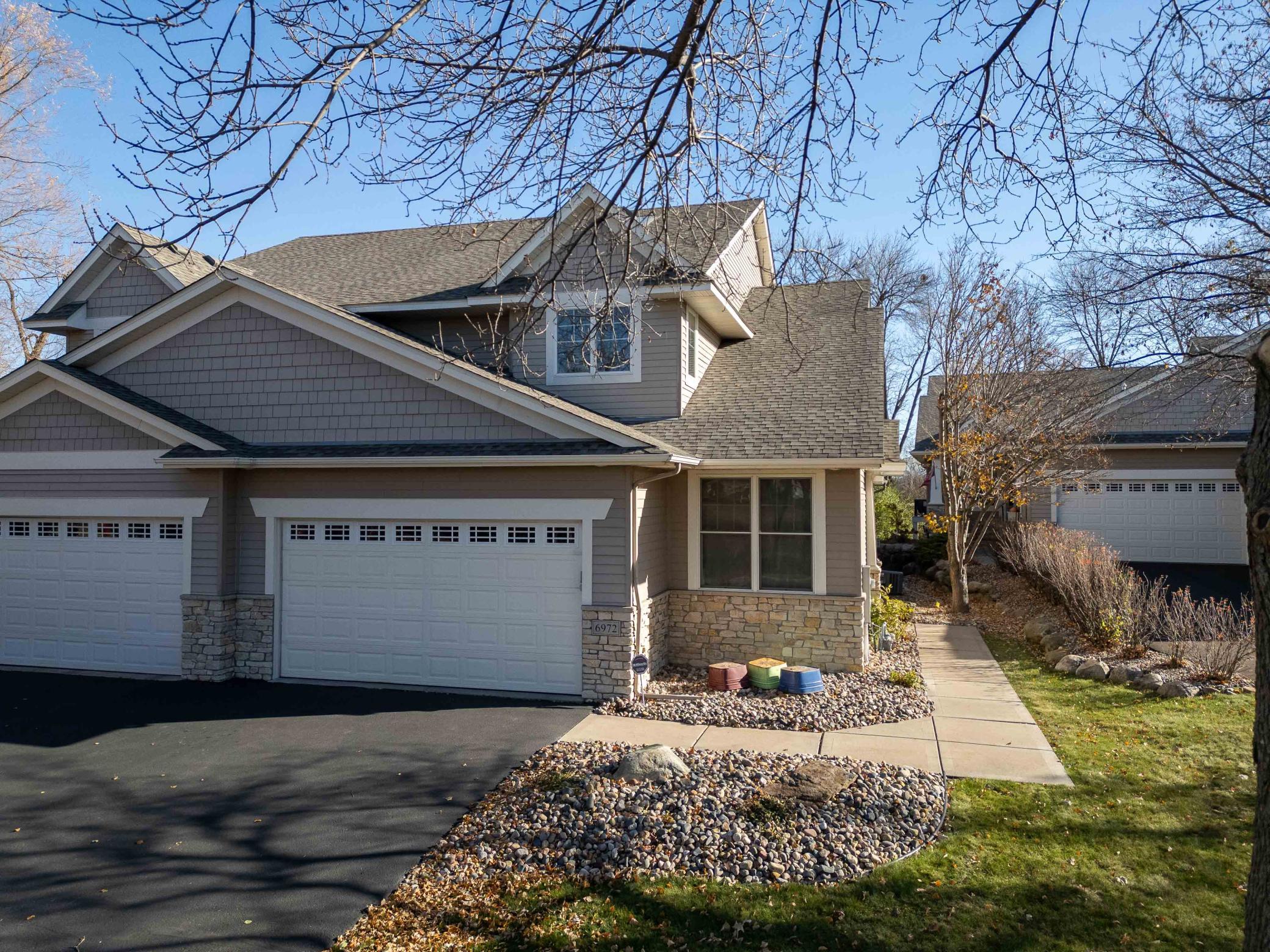Low-maintenance living with curb appeal—welcome home to your private Maple Grove retreat near Eagle Lake