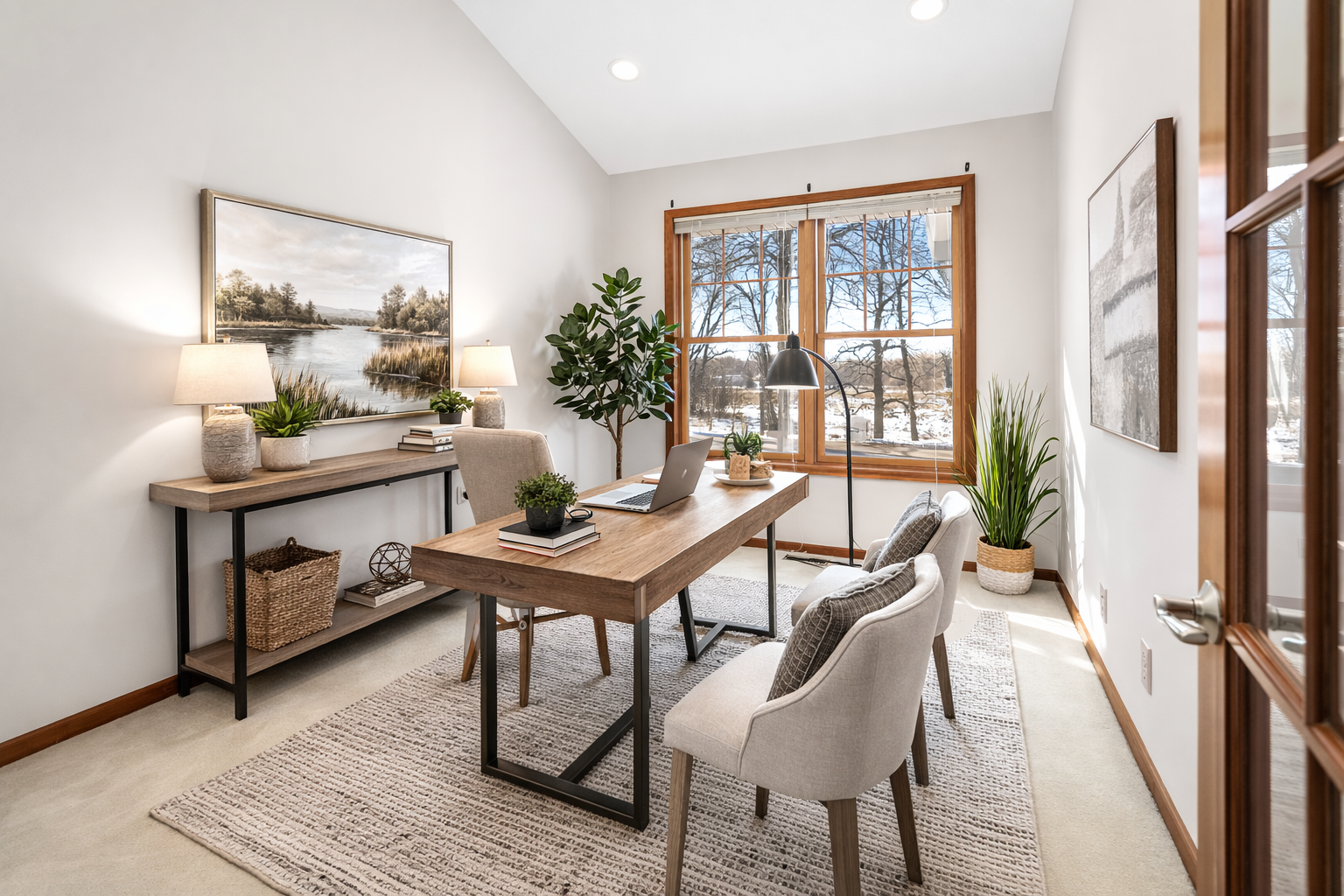 Bright home office featuring oversized window, natural light, and flexible workspace design.
