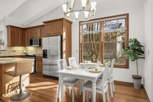 Sunlit dining area with large picture window and open flow to the kitchenâperfect for everyday living and entertaining.