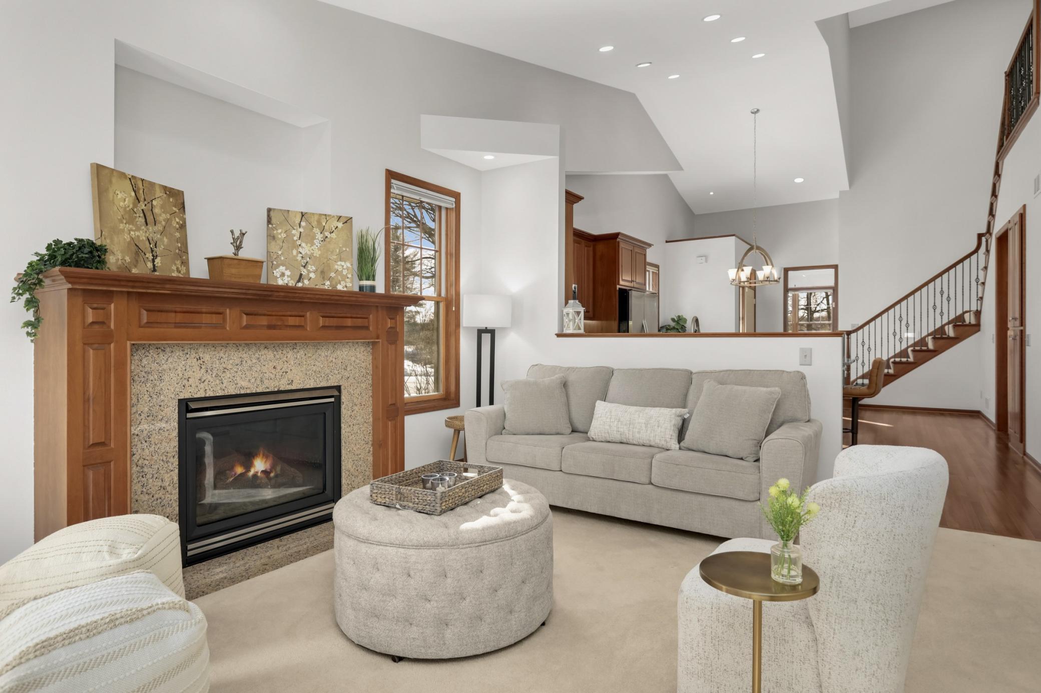 Spacious living room with fireplace and seamless connection to the kitchen, perfect for entertaining in this Eagle Lake home
