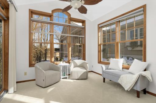 Sun-filled sitting room with expansive windows and peaceful viewsâperfect for morning coffee overlooking Eagle Lake.