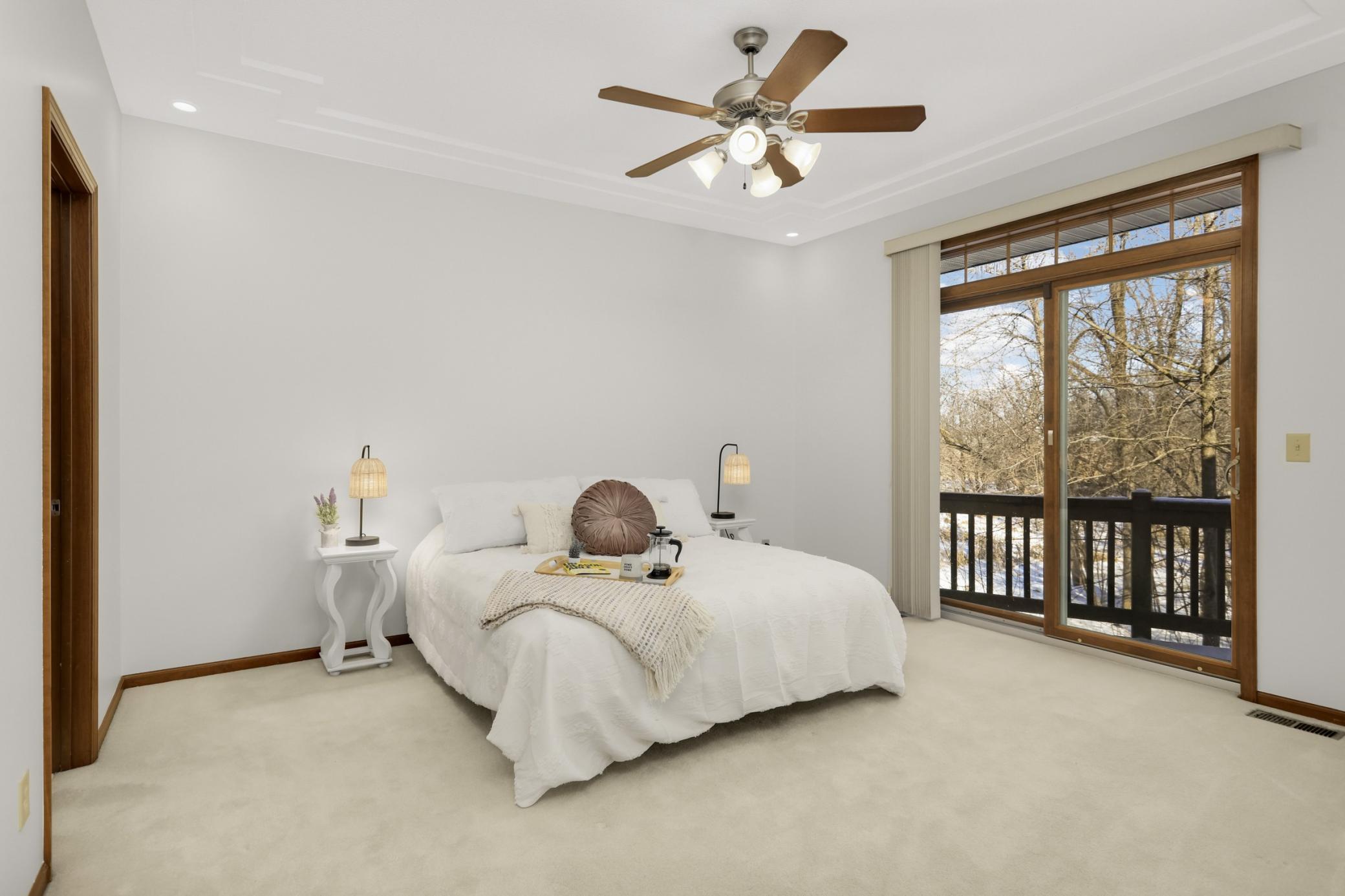 Primary Main Level Bedroom with access to walk out to the deck or enjoy the peaceful views of the wetlands and lake.