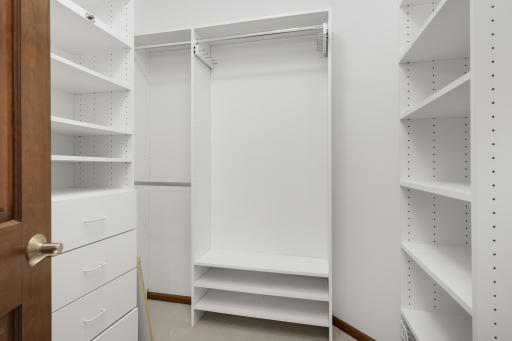 Large ownerâs suite walk-in closet with custom storage system for maximum organization.
