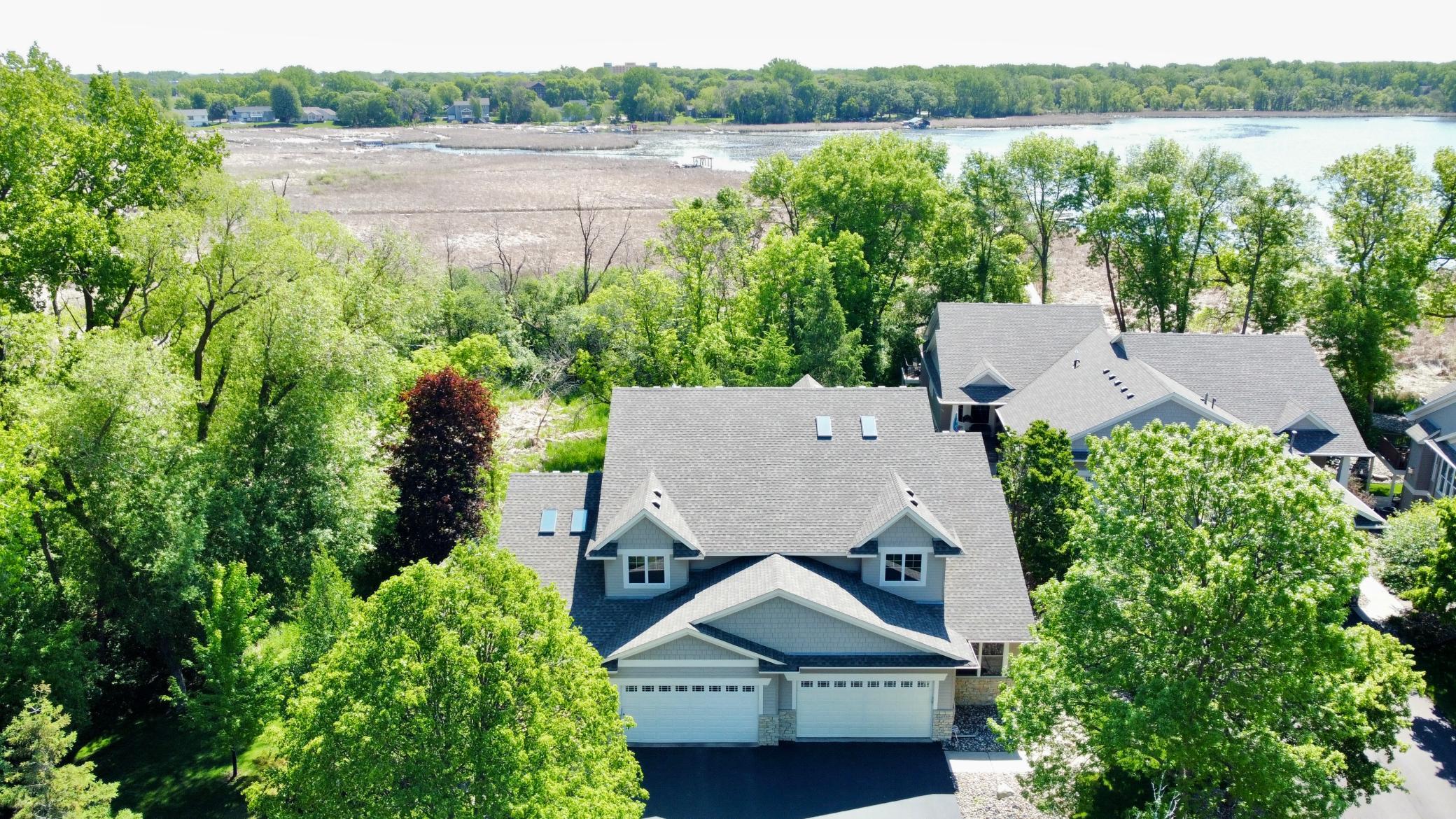 Imagine stepping outside to enjoy Eagle Lake just moments away. With private dock access, serene wetland views, and year-round natural beauty, this is a rare opportunity to enjoy true lakeside living in Maple Grove.