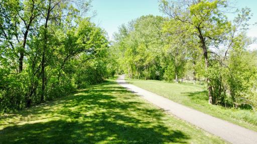 Picturesque walking paths wind through the community, offering a serene setting for daily walks, outdoor recreation, and enjoying nature just steps from your front door.