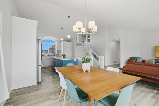 The kitchen, dining, and living areas flow effortlessly together beneath the vaulted ceiling. Thoughtful design and abundant natural light give this home a bright, airy feel.