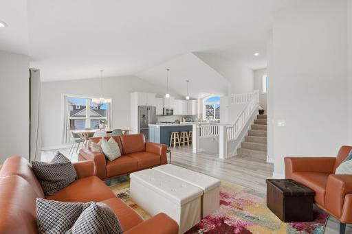 Soaring vaulted ceilings make this main living area feel exceptionally open and spacious. The layout is ideal for both everyday living and entertaining.