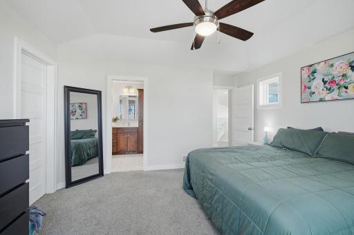 Relax in this bright and spacious vaulted primary bedroom. Its private location away from the other bedrooms is one of the highlights of this unique floor plan.