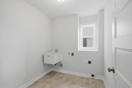This unique bonus room already includes a sink and laundry hookups and could easily be converted into a small kitchenette. It creates exciting possibilities for guests, extended family, hobbies, or additional household needs.