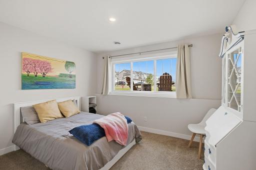 One of two additional bedrooms located on the finished lower level. With four total bedrooms throughout the home, there is plenty of flexibility for family, guests, or office space.