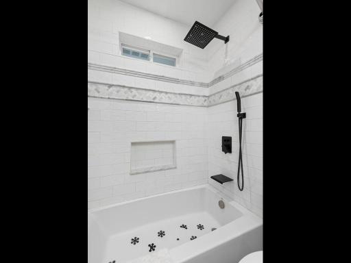 Full bath on the main level with updated finishes and fixtures.