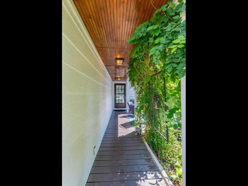 Covered front entry with wood planked ceiling.