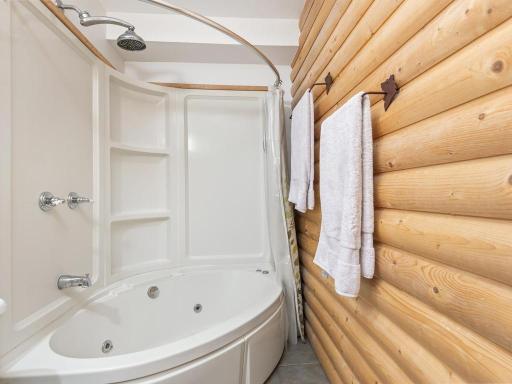 Rustic finishes surround the jetted tub.