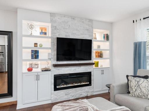 Custom built ins and electric fireplace create warm, welcoming main-level focal point.