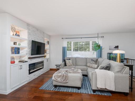 Living area with fireplace and built in shelving.