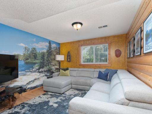 Cozy gathering area just off the lower level family room with scenic wall mural. This could be a 5th bedroom by adding a wall and door.