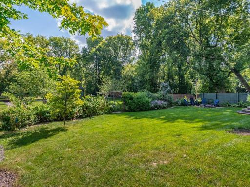 Fenced backyard with abundant plantings for year round vibrancy.