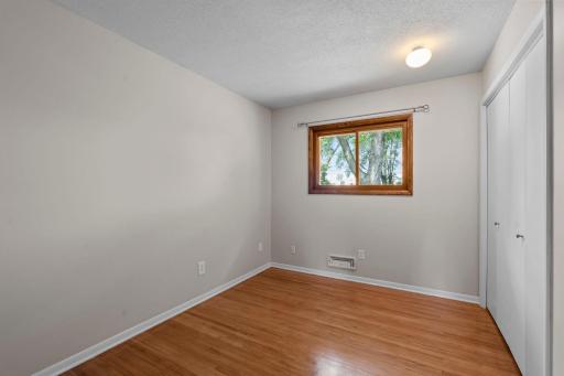 The main level bedroom three features original hardwood flooring.