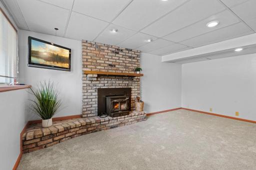 The finished lower level provides a spacious family room centered around a cozy wood-burning fireplace.