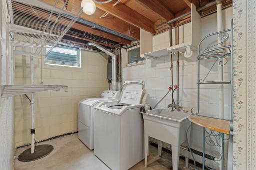 Just steps away, you'll find a clean laundry and utility room leading to a finished three-quarter bathroom.