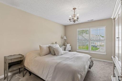 Large primary bedroom with custom closet system and en suite bath.