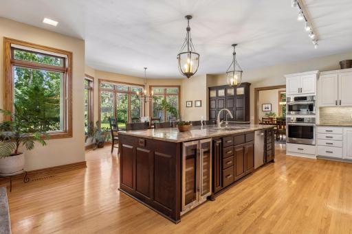 Hardwood floors flow seamlessly from the kitchen into the adjoining living spaces.