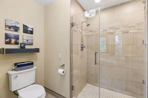 A tiled walk-in shower completes the primary suite’s well-appointed ensuite.