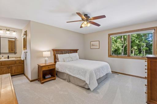Another spacious upper-level bedroom enjoys natural light and peaceful wooded views.